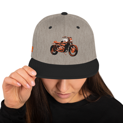Scrambler Snapback Hat in natural heather with black brim, front orange motorcycle graphic