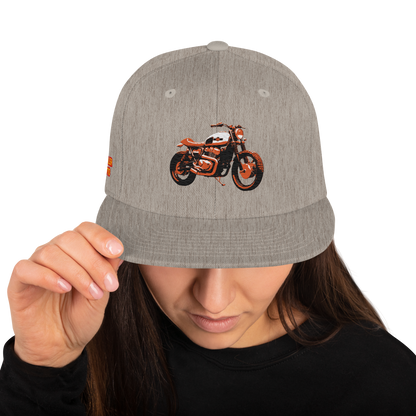 Scrambler Snapback Hat front view, natural heather with black brim and orange motorcycle graphic