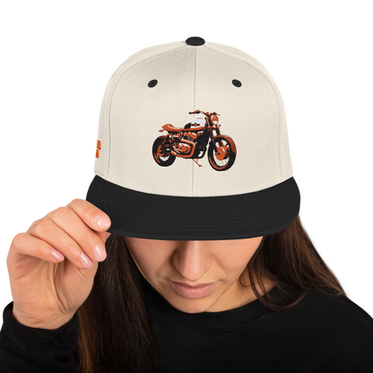 Natural/Black Snapback with front bike graphic, black eyelets, and black brim